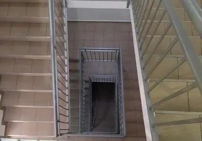 a spiral staircase in a building with a window at Apartment S&S Budva in Budva