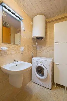 a bathroom with a washing machine and a sink at Apartment S&S Budva in Budva