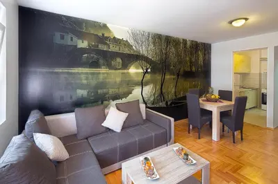 a living room with a couch and a table at Apartment S&S Budva in Budva