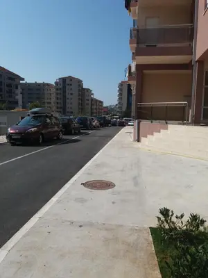 a street with cars parked on the side of the road at Apartment S&S Budva in Budva