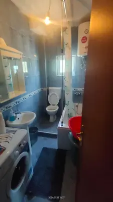 a bathroom with two toilets and a sink at Apartment Panorama Vista 72 in Bar