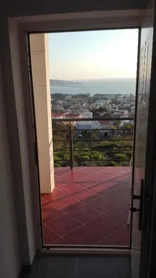 a door to a balcony with a view of a city at Apartment Panorama Vista 72 in Bar