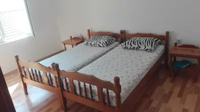 two beds in a bedroom with zebra pillows on them at Apartment Panorama Vista 72 in Bar