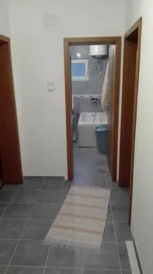 a bathroom with a tub and a toilet and a sink at Apartment Panorama Vista 72 in Bar