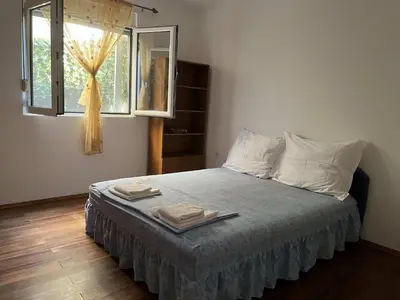 a bedroom with a bed with two towels on it at Apartman Any Bar in Bar