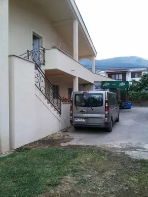 a van parked in a parking lot next to a building at Apartman Any Bar in Bar