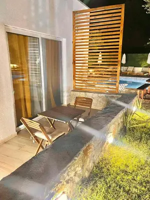 a patio with a table and chairs on a balcony at Eman Resort in Ulcinj
