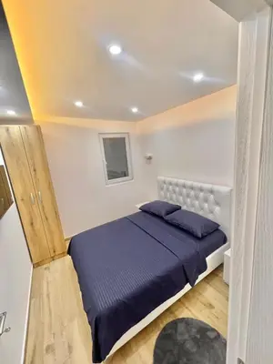 a bedroom with a bed with a blue comforter at Eman Resort in Ulcinj