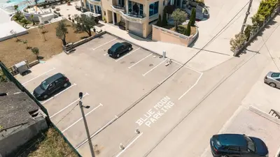 an empty street with cars parked in a parking lot at Hotel Blue Moon in Ulcinj