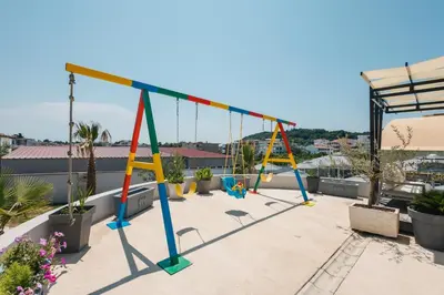 a swing set on top of a roof at Hotel Blue Moon in Ulcinj