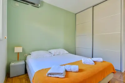 a bedroom with two towels on a bed at Lux Apartman Sofia in Sveti Stefan