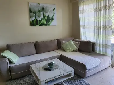 a living room with a couch and a table at Lux Apartment Vidovic in Rafailovici