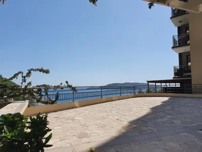 a balcony of a building with the ocean in the background at Lux Apartment Vidovic in Rafailovici
