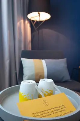 a tray with two candles on a table with a sign at voco - Podgorica by IHG in Podgorica