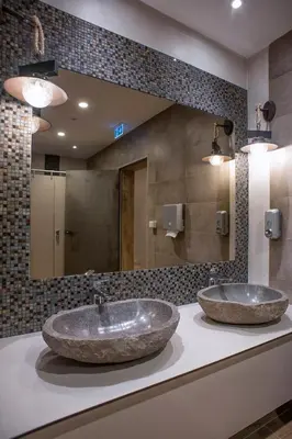 two sinks in a bathroom with a large mirror at voco - Podgorica by IHG in Podgorica