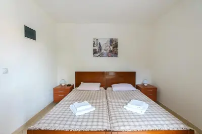 a bedroom with a bed with two white towels on it at Apartments Lora in Bar