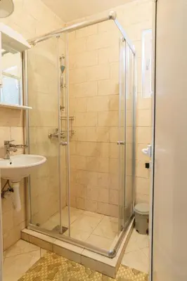 a bathroom with a shower and a sink at Apartments Lora in Bar