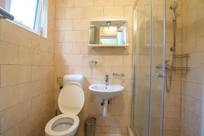 a bathroom with a toilet and a sink and a shower at Apartments Lora in Bar