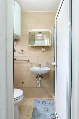 a bathroom with a sink and a toilet at Apartments Lora in Bar