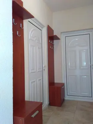 a room with a white door and a wooden cabinet at Apartments Lora in Bar