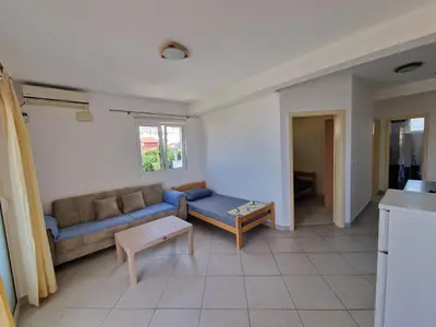 a living room with a couch and a table at Ago Apartmani in Dobra Voda