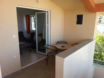 a living room with a table and a dining room at Ago Apartmani in Dobra Voda