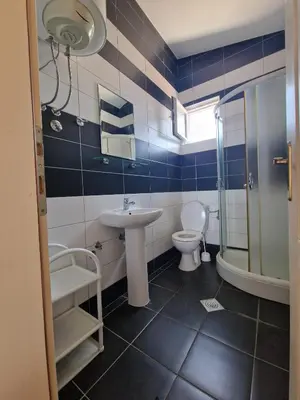 a blue and white bathroom with a sink and a toilet at Ago Apartmani in Dobra Voda
