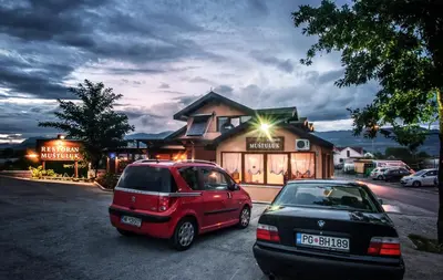 a red car parked in front of a building at Apartman in Danilovgrad