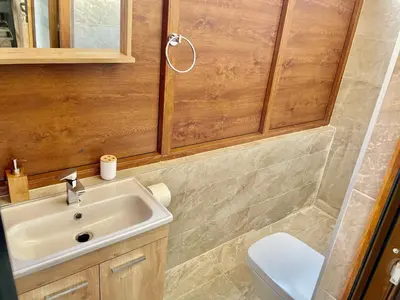 a bathroom with a sink and a toilet at Heart of the City Stunning city View,Balcony Free Wi-Fi in Podgorica