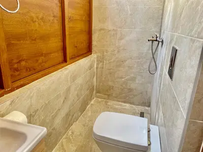 a bathroom with a toilet and a sink at Heart of the City Stunning city View,Balcony Free Wi-Fi in Podgorica