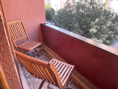 two chairs sitting on a balcony next to a window at Heart of the City Stunning city View,Balcony Free Wi-Fi in Podgorica