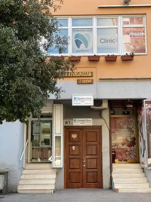 a building with a wooden door and a store at Heart of the City Stunning city View,Balcony Free Wi-Fi in Podgorica
