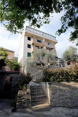 a building with a gate in front of it at Apartments Drašković Mirišta in Petrovac na Moru