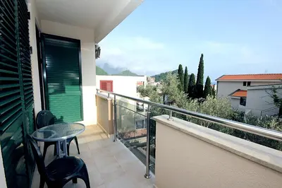 a balcony with a table and chairs on a balcony at Apartments Drašković Mirišta in Petrovac na Moru