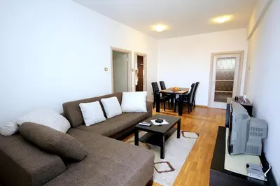 a living room with a couch and a tv at Apartments Drašković Mirišta in Petrovac na Moru