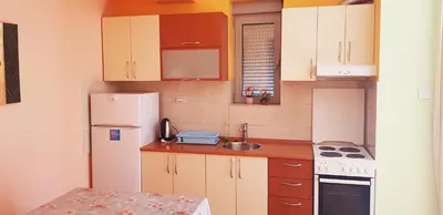a kitchen with a white refrigerator and a sink at Centar New Loki Apartments in Budva