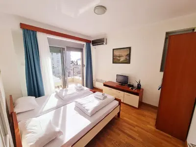 a bedroom with two beds and a window at Centar New Loki Apartments in Budva
