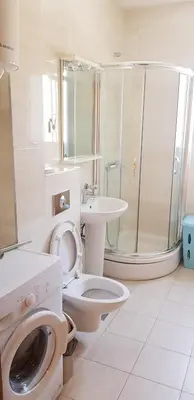 a bathroom with a toilet and a sink and a shower at Centar New Loki Apartments in Budva