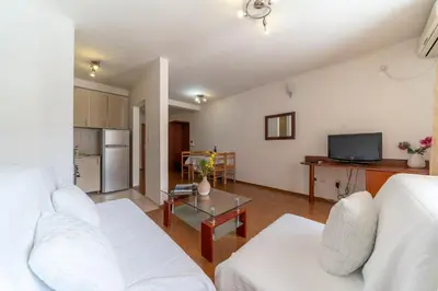 a living room with a white couch and a table at SMS Apartments in Budva