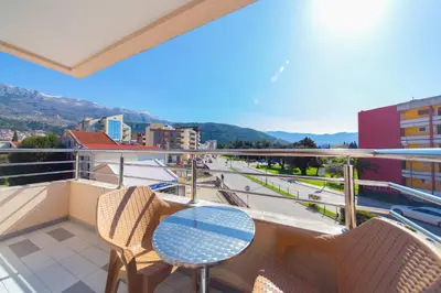 a balcony with chairs and a table and a view at SMS Apartments in Budva
