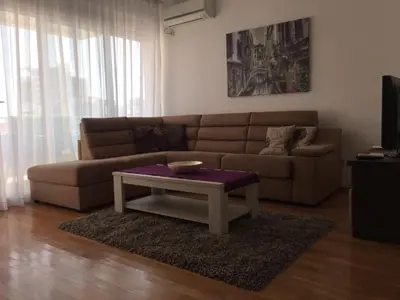a living room with a couch and a coffee table at City & Sea Apartments in Budva
