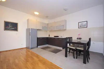 a kitchen with a black table and a black refrigerator at City & Sea Apartments in Budva