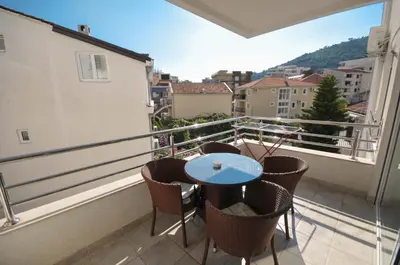 a balcony with a table and chairs on a balcony at City & Sea Apartments in Budva