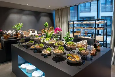 a buffet with many bowls of food on a table at Crowne Plaza Podgorica by IHG in Podgorica