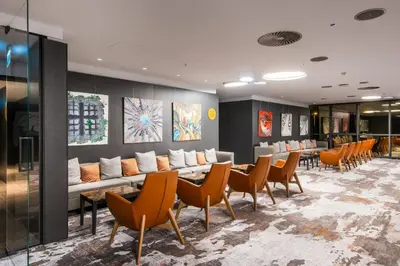 a waiting room with a long couch and chairs at Crowne Plaza Podgorica by IHG in Podgorica