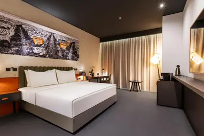 a hotel room with a bed and a desk at Crowne Plaza Podgorica by IHG in Podgorica
