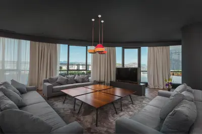 a living room with couches and a table at Crowne Plaza Podgorica by IHG in Podgorica