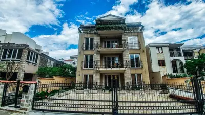 a large building with a fence in front of it at Villa Franeta Apartments in Budva
