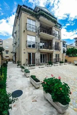 a large building with flowers in front of it at Villa Franeta Apartments in Budva