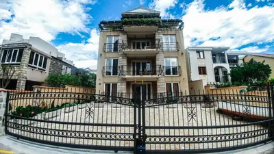 a building with a fence in front of it at Villa Franeta Apartments in Budva